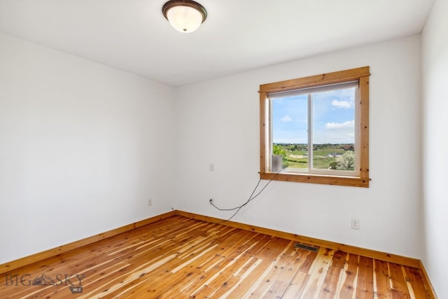 418 May Ln, Belgrade, MT 59714 - unfurnished room with baseboards and light wood-style flooring