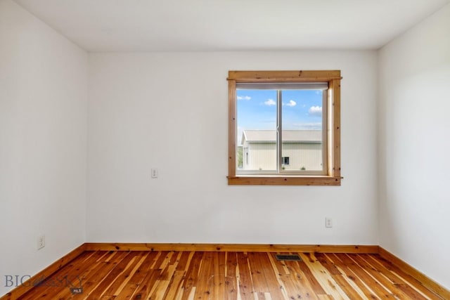 418 May Ln, Belgrade, MT 59714 - spare room with baseboards and hardwood / wood-style flooring