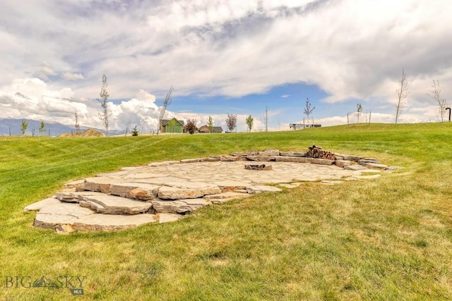 418 May Ln, Belgrade, MT 59714 - view of green lawn featuring a fire pit and a patio