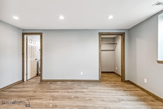 418 May Ln, Belgrade, MT 59714 - unfurnished bedroom featuring light wood-style flooring, recessed lighting, and a spacious closet