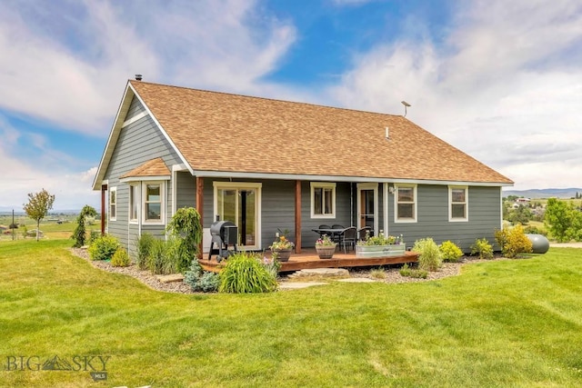 418 May Ln, Belgrade, MT 59714 - back of property with a yard, a shingled roof, and a wooden deck