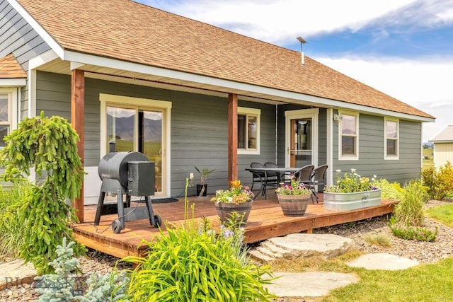 418 May Ln, Belgrade, MT 59714 - rear view of house with a deck, outdoor dining space, and roof with shingles