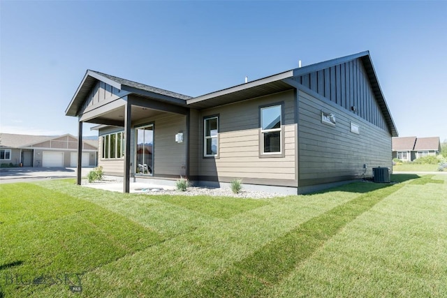 702 Pleiades, Livingston, MT 59047 - back of property with board and batten siding and a yard