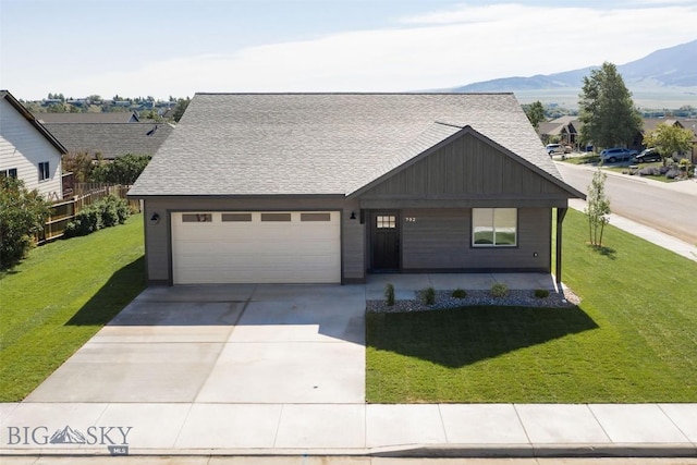 702 Pleiades, Livingston, MT 59047 - view of front of house featuring board and batten siding, driveway, a mountain view, and a front yard