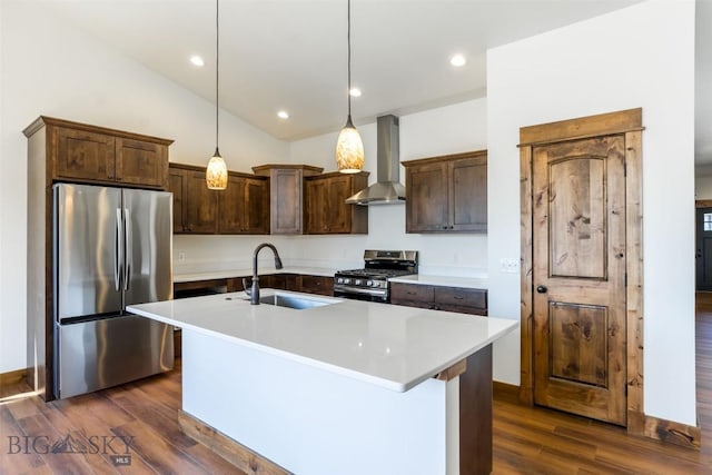 702 Pleiades, Livingston, MT 59047 - kitchen featuring appliances with stainless steel finishes, wall chimney exhaust hood, dark brown cabinetry, dark wood-style flooring, and light countertops