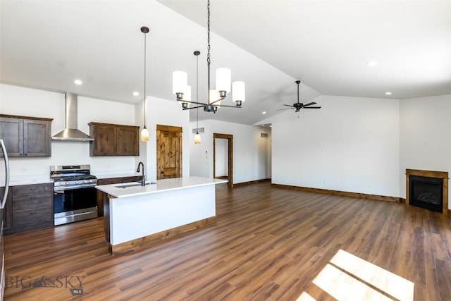 702 Pleiades, Livingston, MT 59047 - kitchen with gas range, wall chimney exhaust hood, open floor plan, a ceiling fan, and lofted ceiling