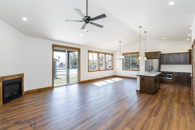 702 Pleiades, Livingston, MT 59047 - kitchen with open floor plan, stainless steel appliances, lofted ceiling, dark brown cabinetry, and a kitchen island with sink