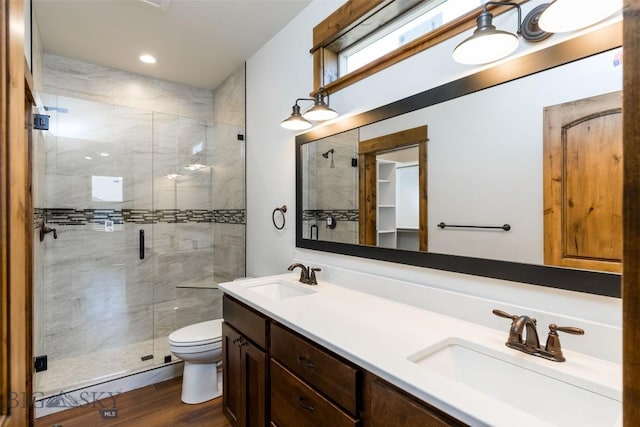 702 Pleiades, Livingston, MT 59047 - bathroom featuring a stall shower, double vanity, and wood finished floors