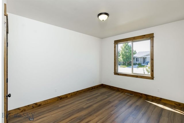702 Pleiades, Livingston, MT 59047 - empty room featuring baseboards and dark wood-type flooring