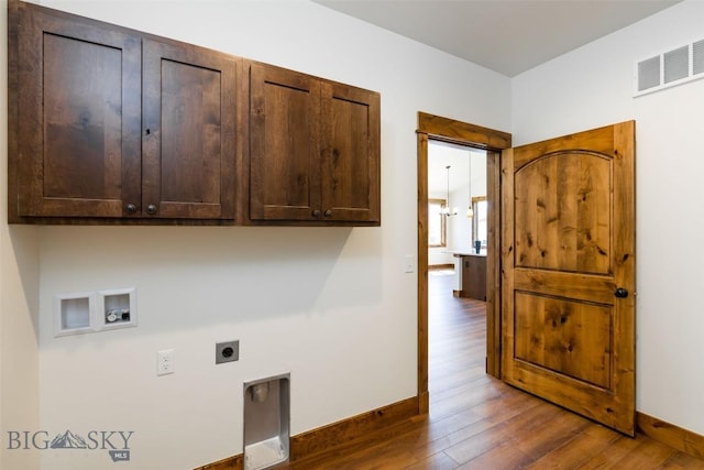 702 Pleiades, Livingston, MT 59047 - washroom featuring cabinet space, hookup for a washing machine, electric dryer hookup, and dark wood-style floors