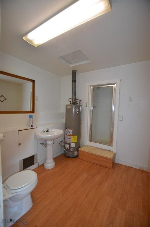 103 Flick, Sheridan, MT 59749 - bathroom featuring gas water heater and wood finished floors