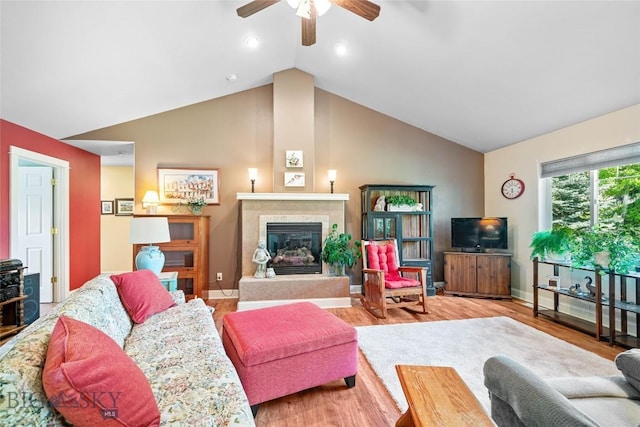 944 Forest Glen Dr, Bozeman, MT 59718 - living area featuring ceiling fan, lofted ceiling, a tile fireplace, wood finished floors, and recessed lighting