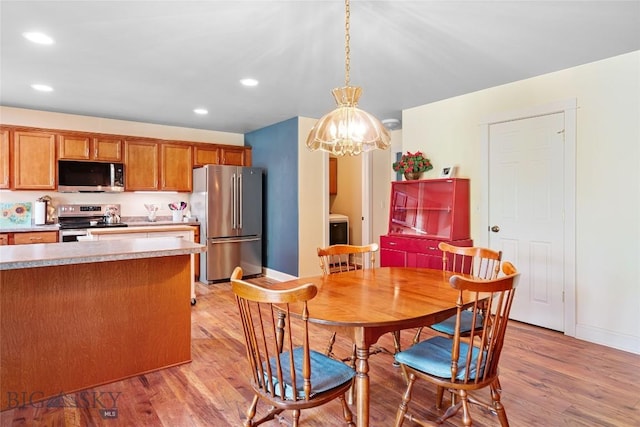 944 Forest Glen Dr, Bozeman, MT 59718 - dining area featuring light wood-style flooring, washer / clothes dryer, recessed lighting, and a chandelier