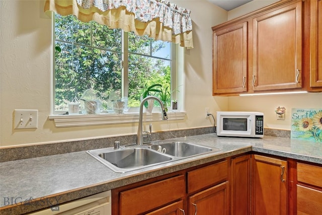 944 Forest Glen Dr, Bozeman, MT 59718 - kitchen with white microwave, dishwasher, healthy amount of natural light, and brown cabinets
