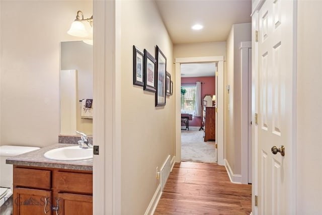 944 Forest Glen Dr, Bozeman, MT 59718 - corridor featuring a sink and wood finished floors