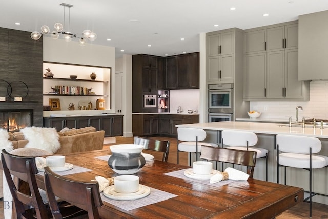 544 Grey Drake, Big Sky, MT 59716 - dining space with wood finished floors, a fireplace, and recessed lighting