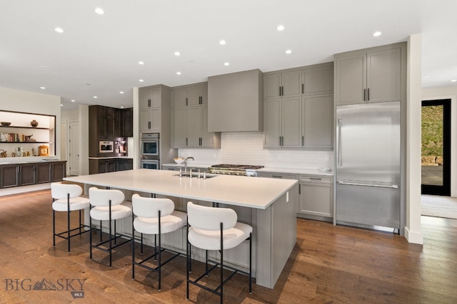 544 Grey Drake, Big Sky, MT 59716 - kitchen with appliances with stainless steel finishes, gray cabinets, a spacious island, light countertops, and recessed lighting