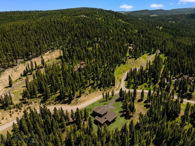 544 Grey Drake, Big Sky, MT 59716 - aerial overview of property's location with a forest and a mountainous background