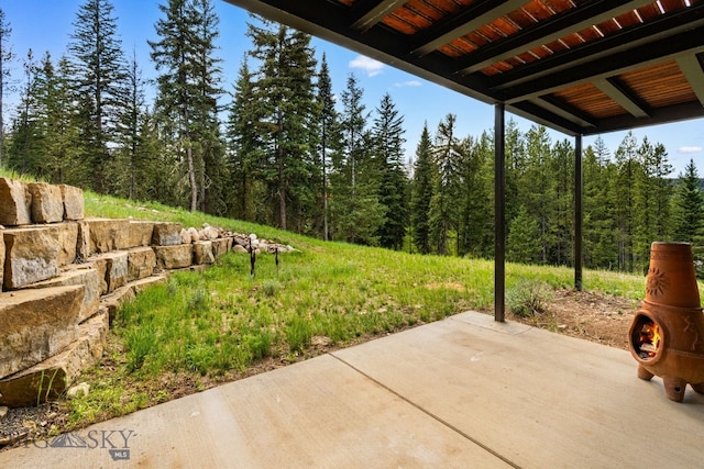544 Grey Drake, Big Sky, MT 59716 - view of patio featuring a wooded view