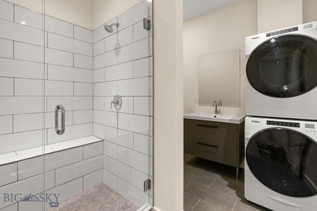544 Grey Drake, Big Sky, MT 59716 - bathroom featuring stacked washer and clothes dryer, a stall shower, tile patterned floors, and vanity
