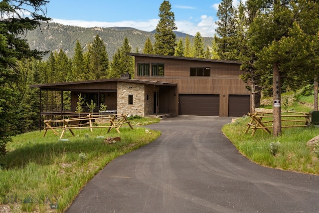 544 Grey Drake, Big Sky, MT 59716 - view of front of property with asphalt driveway, a mountain view, and an attached garage