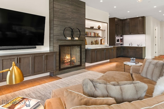 544 Grey Drake, Big Sky, MT 59716 - living room with light wood-type flooring, a fireplace, and recessed lighting