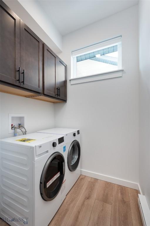 1942 Southbridge Unit B, Bozeman, MT 59718 - laundry area featuring cabinet space, separate washer and dryer, light wood finished floors, and healthy amount of natural light