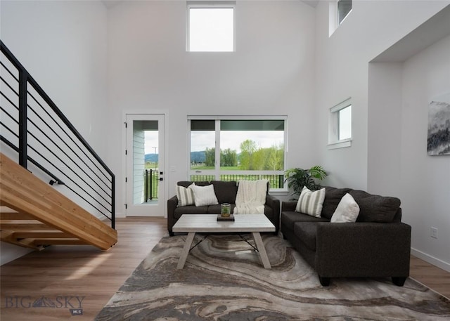 1942 Southbridge Unit B, Bozeman, MT 59718 - living room with a high ceiling, stairway, and wood finished floors