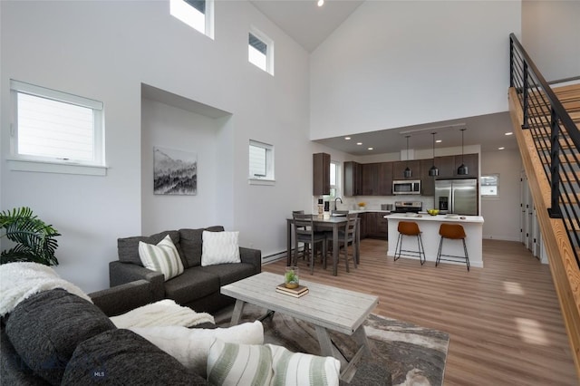 1942 Southbridge Unit B, Bozeman, MT 59718 - living area featuring light wood finished floors, high vaulted ceiling, and stairs