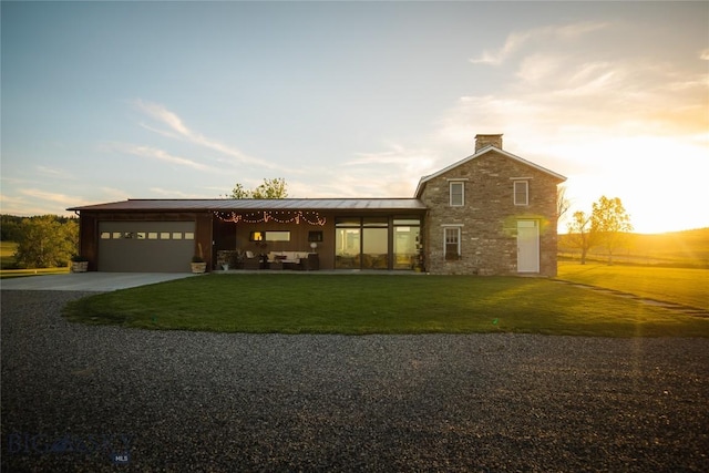 802 Deadmans Canyon Rd, Reed Point, MT 59069 - view of front of house with driveway, a standing seam roof, a garage, and a front lawn