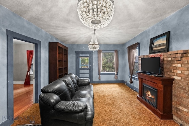 523 N I St, Livingston, MT 59047 - living area featuring a chandelier, a glass covered fireplace, and a textured ceiling