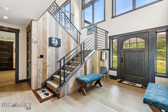 146 Outlook Trl, Big Sky, MT 59716 - foyer entrance featuring stairway, wood-type flooring, wooden walls, recessed lighting, and a high ceiling