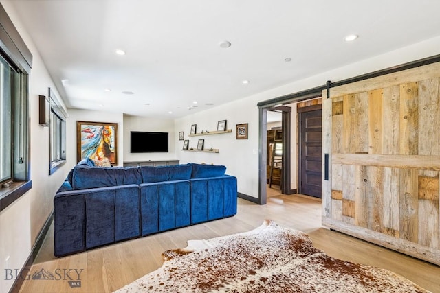 146 Outlook Trl, Big Sky, MT 59716 - living room with light wood-style flooring, a barn door, and recessed lighting