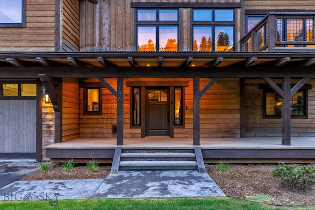 146 Outlook Trl, Big Sky, MT 59716 - exterior entry at dusk featuring covered porch