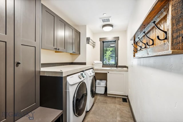 146 Outlook Trl, Big Sky, MT 59716 - laundry room featuring washing machine and clothes dryer, cabinet space, and light tile patterned floors