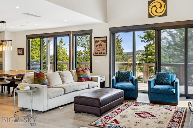 146 Outlook Trl, Big Sky, MT 59716 - living area featuring wood finished floors, a chandelier, and recessed lighting