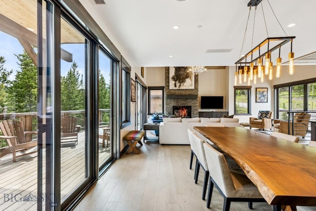 146 Outlook Trl, Big Sky, MT 59716 - dining room with light wood-style flooring, a fireplace, and recessed lighting