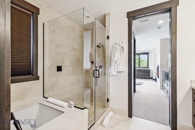 146 Outlook Trl, Big Sky, MT 59716 - full bathroom featuring a bath, a shower stall, vanity, and tile patterned flooring