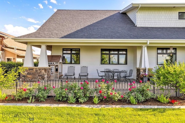 33 Oasis Trl, Bozeman, MT 59718 - back of house featuring a shingled roof and a porch