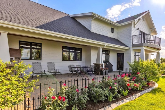 33 Oasis Trl, Bozeman, MT 59718 - rear view of property with roof with shingles, a balcony, and a patio