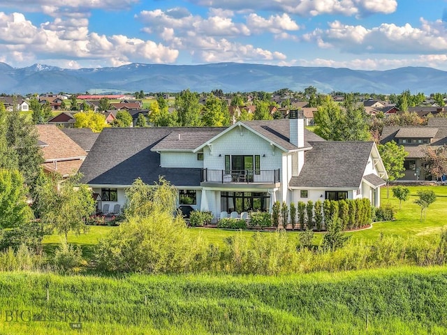 33 Oasis Trl, Bozeman, MT 59718 - back of house featuring a balcony, a mountain view, a chimney, and a residential view