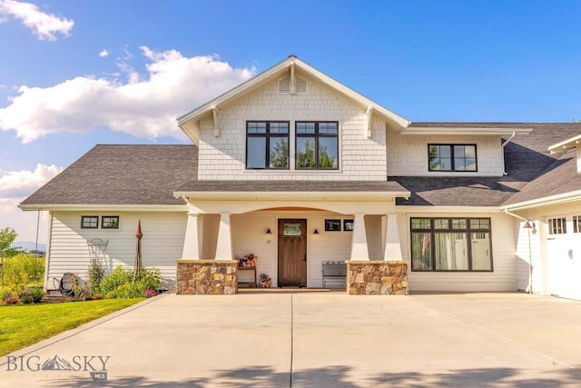 33 Oasis Trl, Bozeman, MT 59718 - craftsman-style house with a porch, a shingled roof, driveway, and stone siding