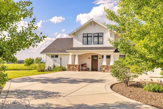 33 Oasis Trl, Bozeman, MT 59718 - craftsman inspired home with a porch, curved driveway, a front yard, and a shingled roof