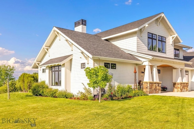 33 Oasis Trl, Bozeman, MT 59718 - view of front of house with a front yard, roof with shingles, and a chimney