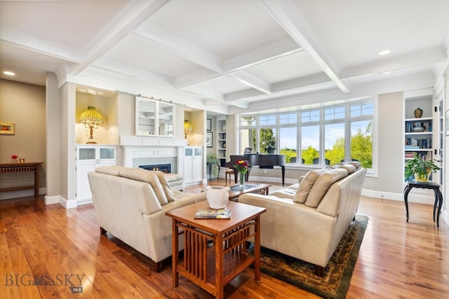 33 Oasis Trl, Bozeman, MT 59718 - living area with light wood-style flooring, recessed lighting, beamed ceiling, coffered ceiling, and a warm lit fireplace