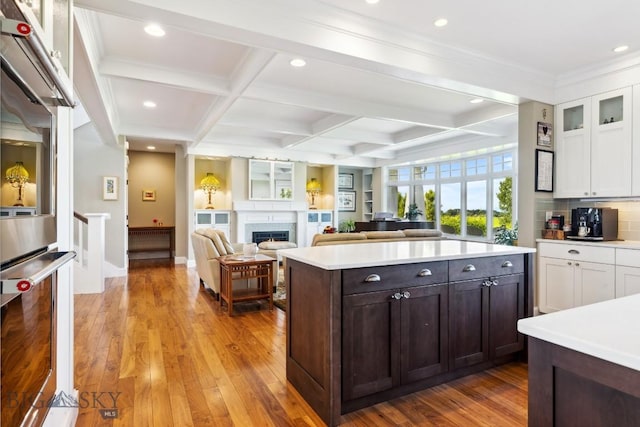33 Oasis Trl, Bozeman, MT 59718 - kitchen with white cabinetry, recessed lighting, light countertops, dark brown cabinets, and beam ceiling