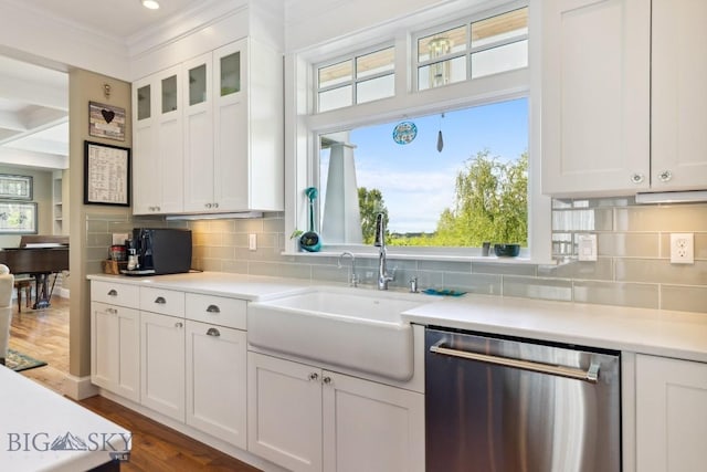 33 Oasis Trl, Bozeman, MT 59718 - kitchen with stainless steel dishwasher, light countertops, white cabinets, healthy amount of natural light, and ornamental molding