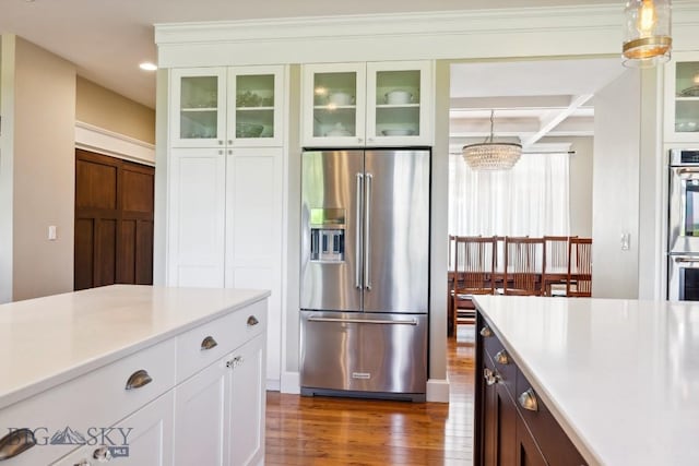 33 Oasis Trl, Bozeman, MT 59718 - kitchen with appliances with stainless steel finishes, dark wood-style floors, light countertops, white cabinetry, and coffered ceiling