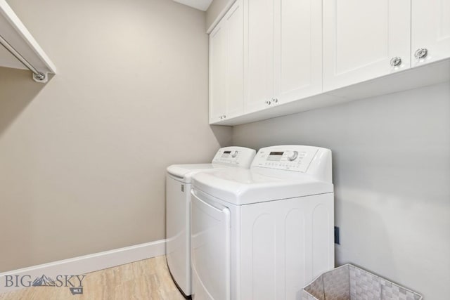 33 Oasis Trl, Bozeman, MT 59718 - laundry room with washing machine and dryer, cabinet space, and light wood-type flooring