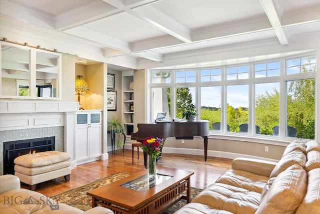 33 Oasis Trl, Bozeman, MT 59718 - living area with coffered ceiling, wood finished floors, a warm lit fireplace, beam ceiling, and ornamental molding